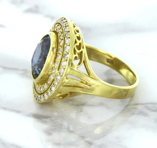 4.23ct Oval Blue Spinel Ring with Double Diamond Halo in 14K Yellow Gold