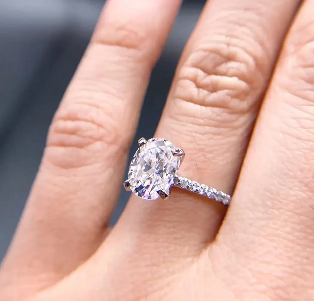 Oval Center Stone 4 Prongs Diamond Accent Ice Solitaire Ring