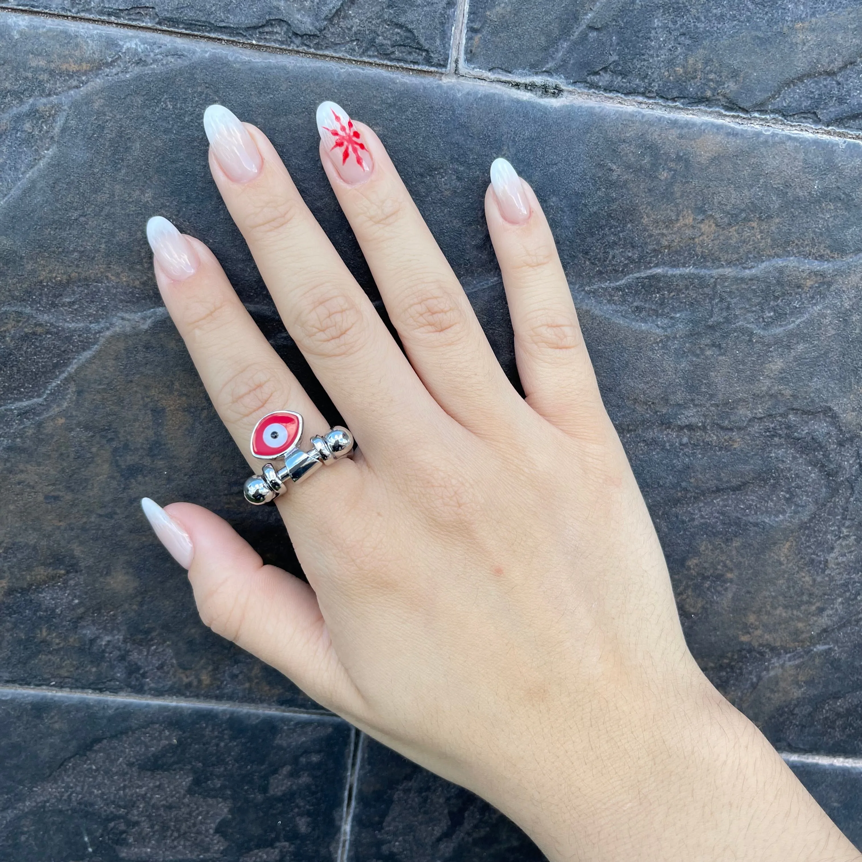 Silver ring with red eye