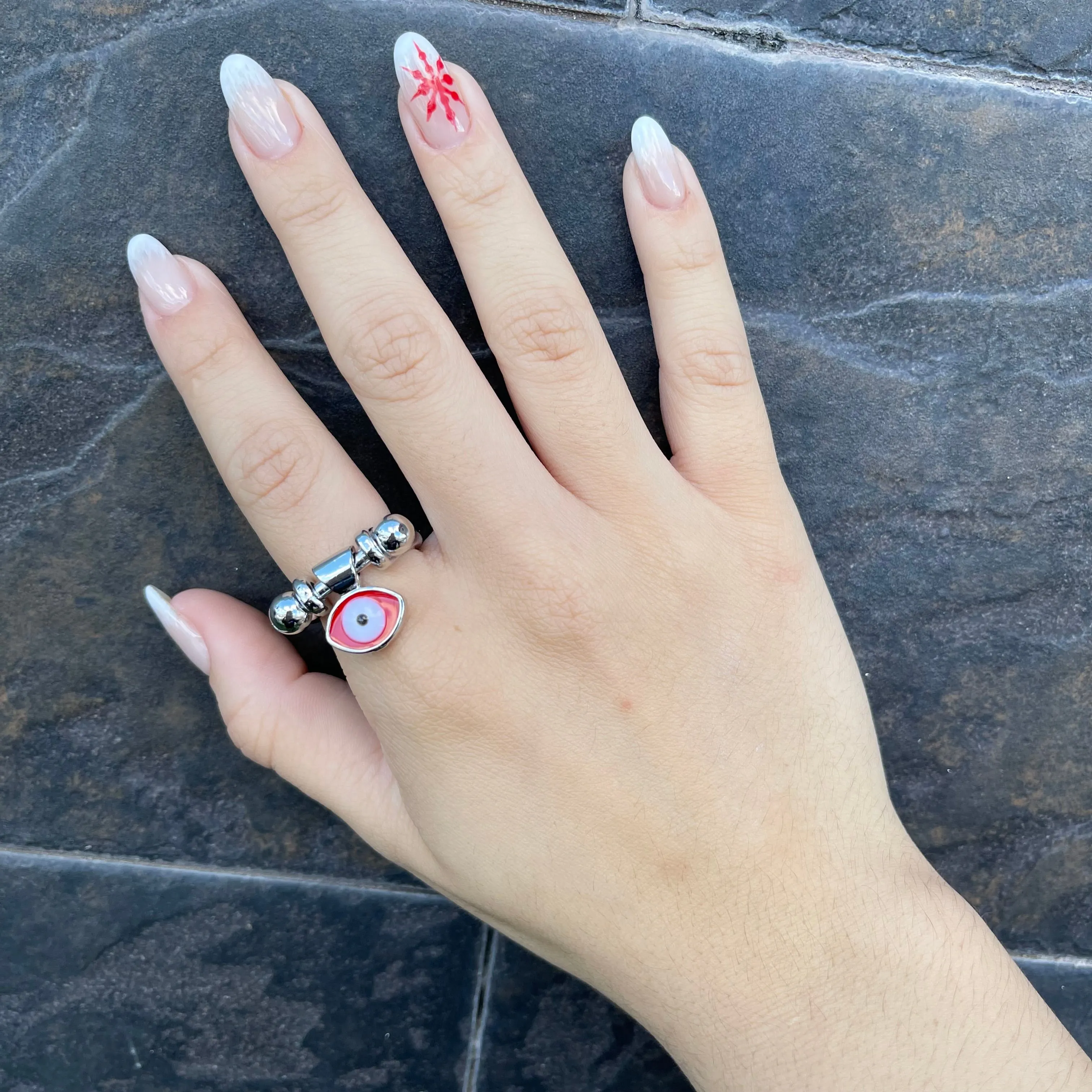 Silver ring with red eye